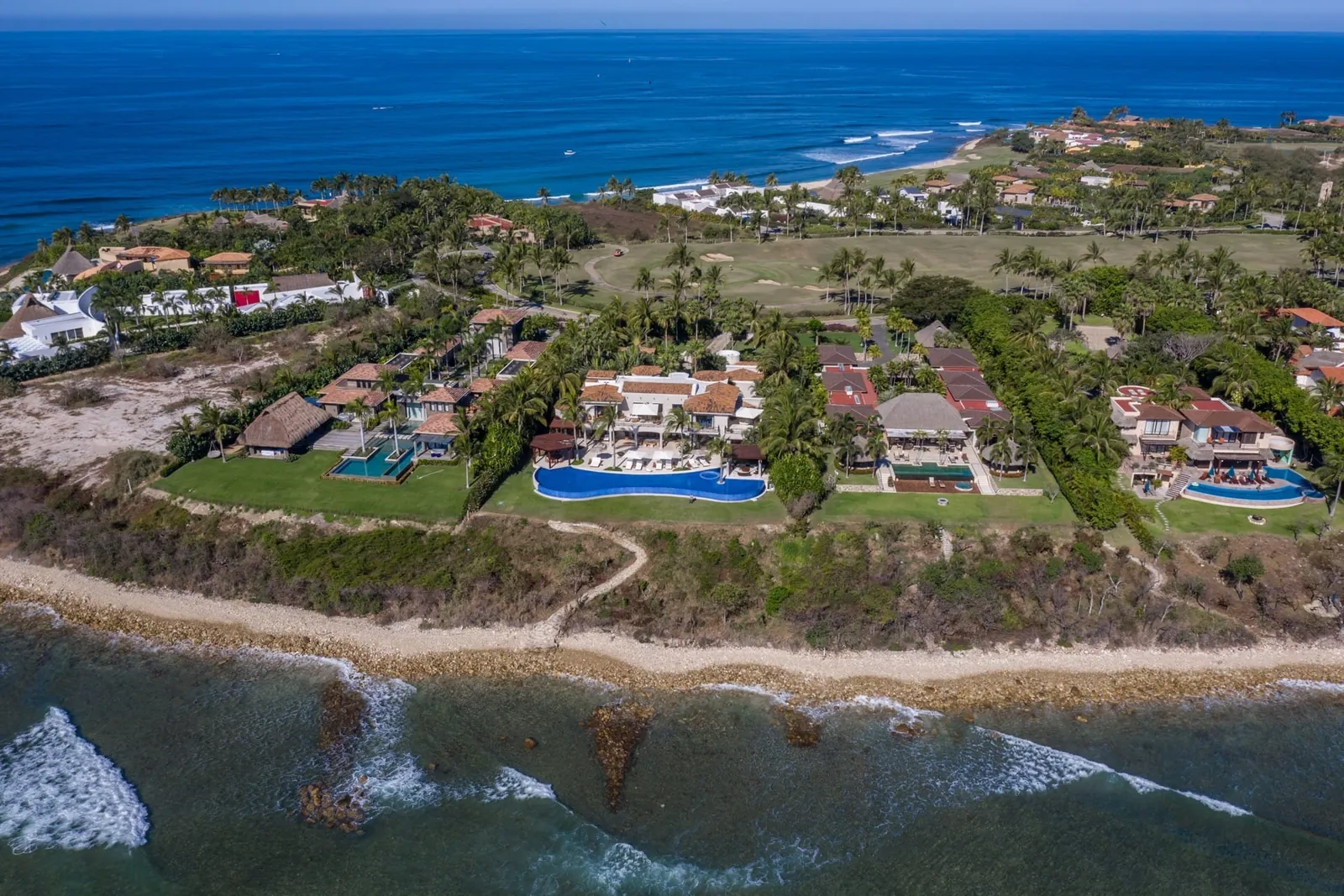 Casa La Vida above the reef and the shoreline on the point