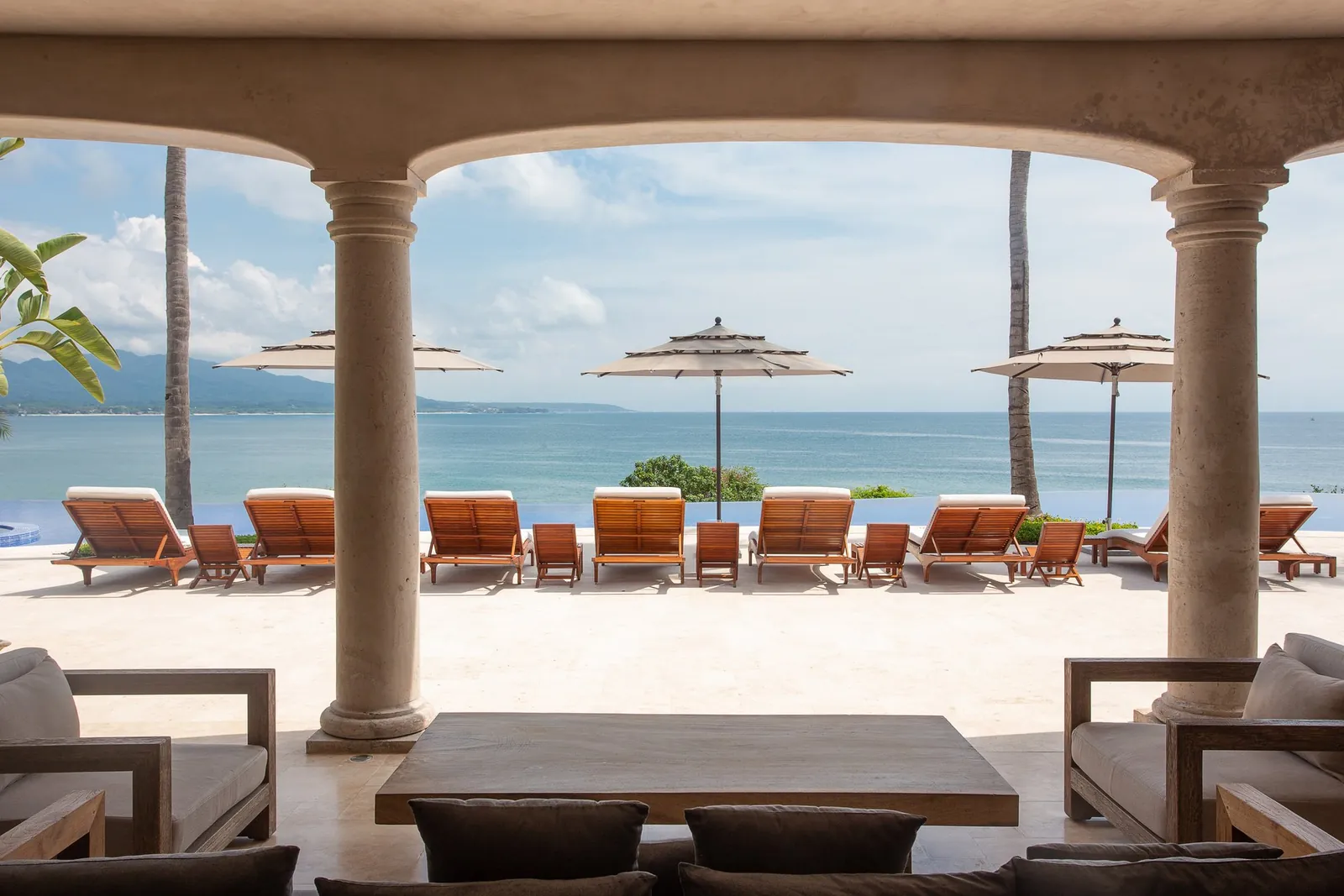 The arched terrace framing the pool and the bay