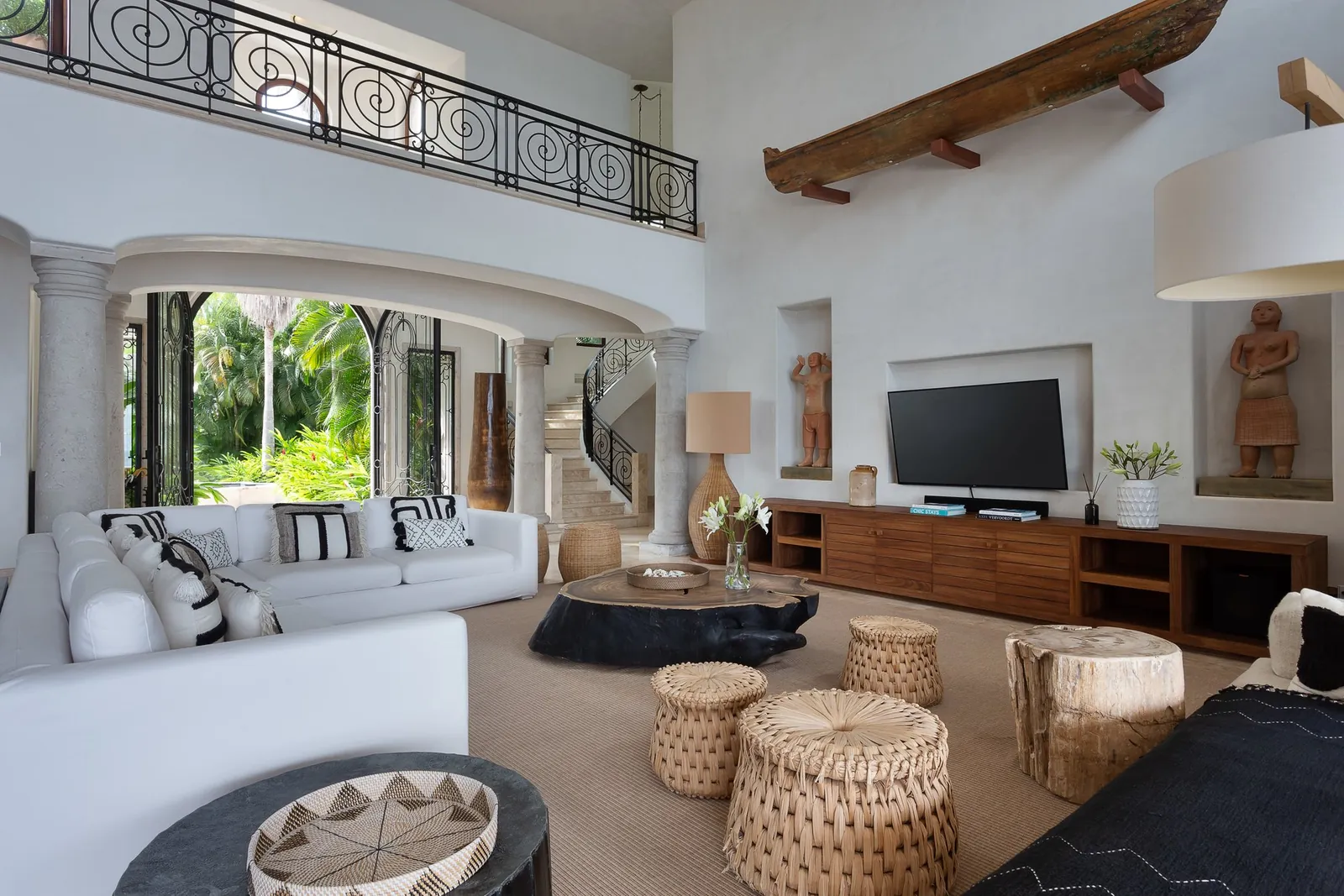 The double-height living room with its wrought-iron gallery