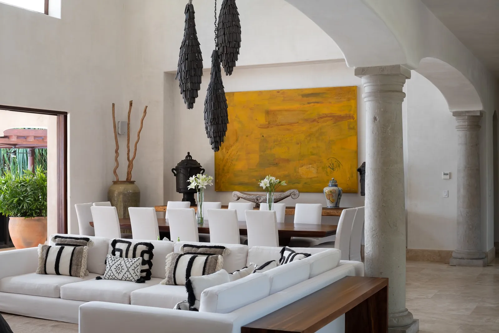 The living room, dining table and a large yellow painting