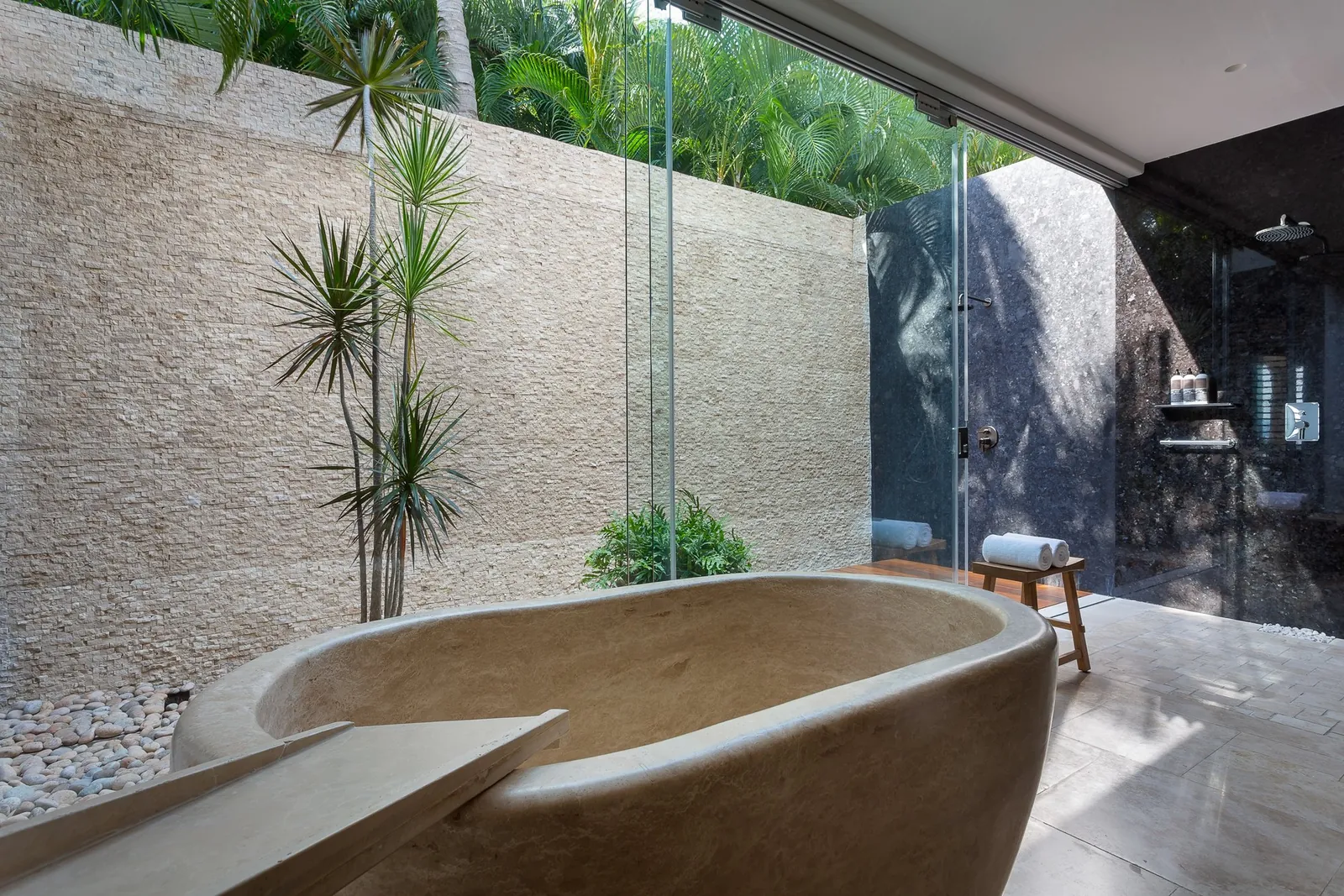 Master Suite 1: the stone tub and outdoor shower in a walled garden