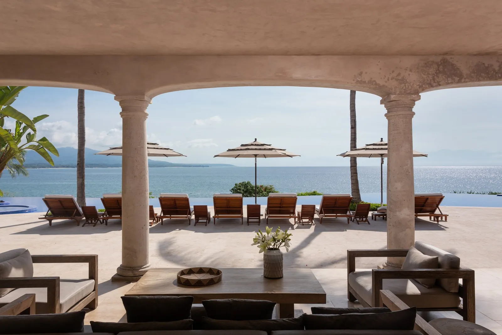 The terrace lounge under the stone arches, looking out to sea