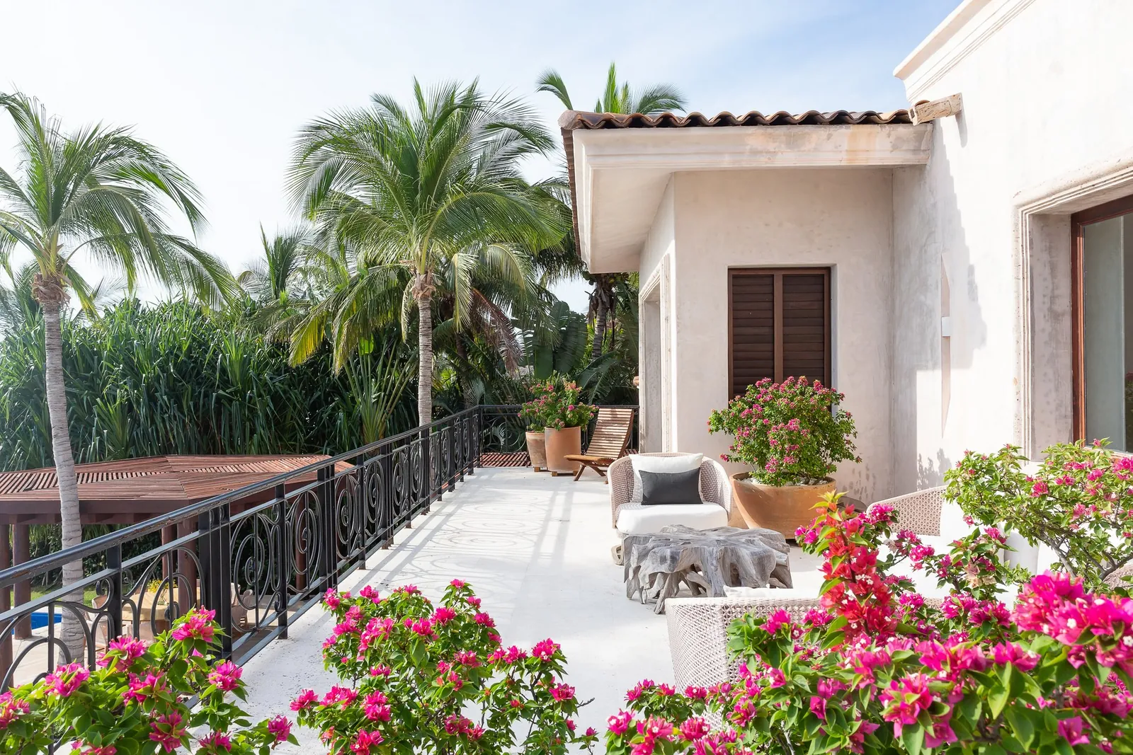 Bougainvillea and armchairs on the upper terrace