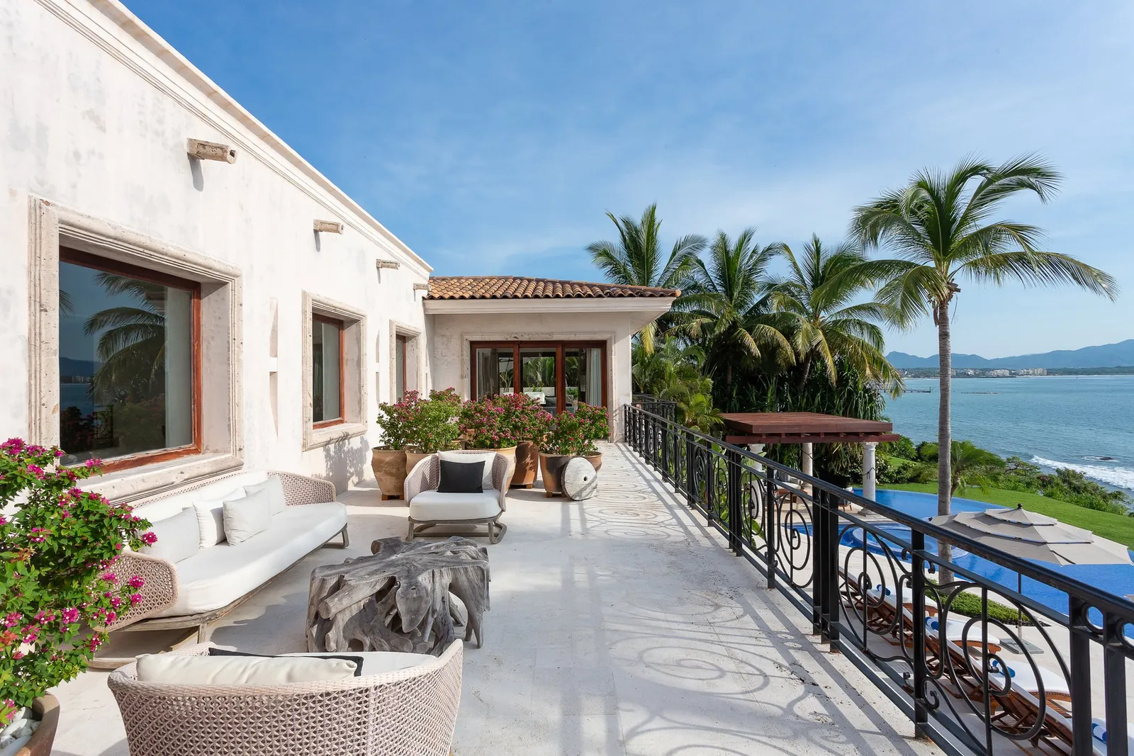 The upper terrace lounge with bougainvillea and the ocean