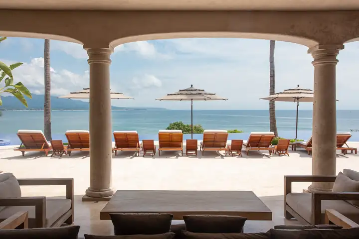The arched terrace framing the pool and the bay