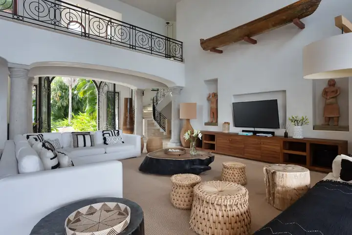 The double-height living room with its wrought-iron gallery