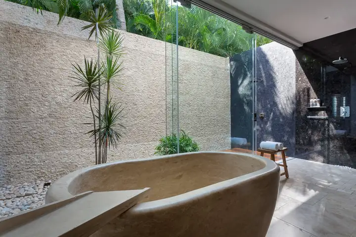 Master Suite 1: the stone tub and outdoor shower in a walled garden