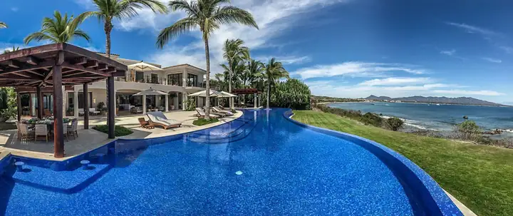 A panorama of the pergola, the pool and the bay